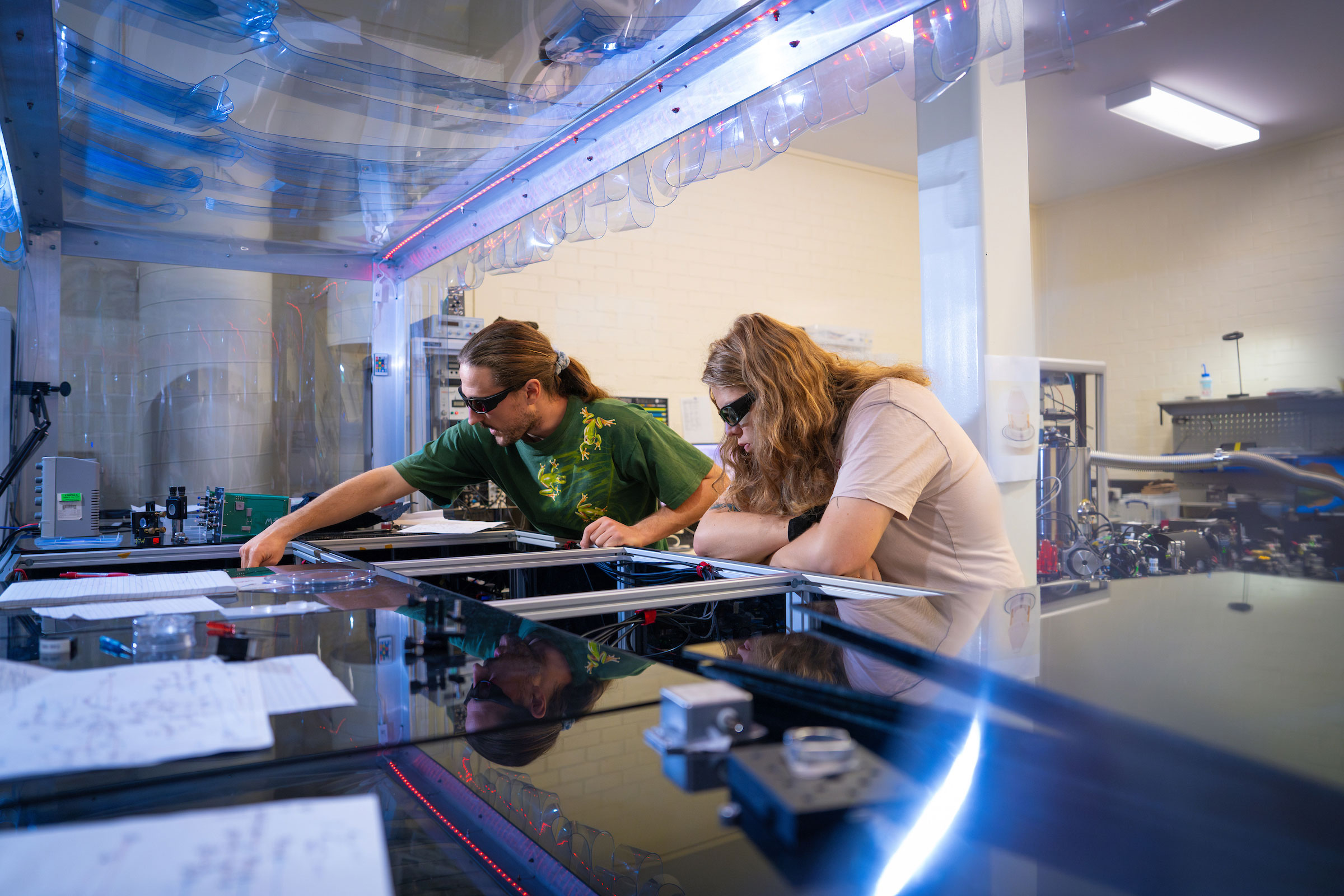 Researchers photographed in the ANU Centre for Gravitational Astrophysics (CGA) Lab