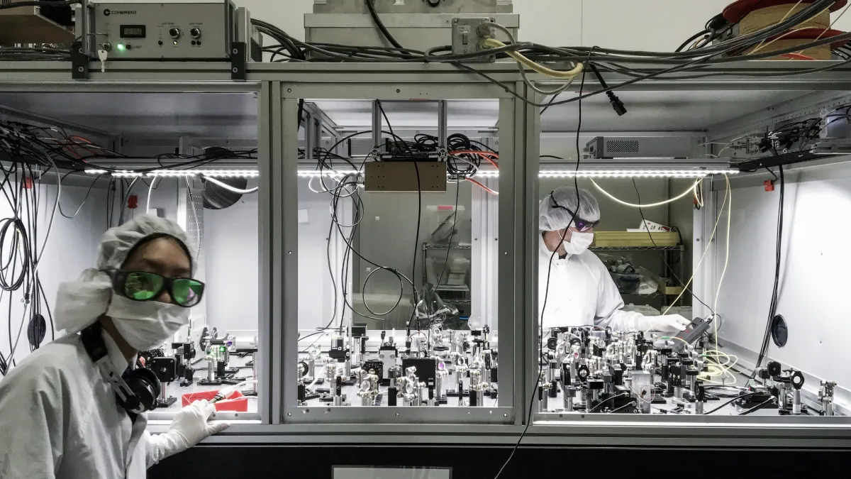 CGA PhD student Nutsinee Kijbunchoo (left) and postdoc Dr Terry McRae (right) building one of the squeezer tables at LIGO Hanford. Photo credit: N. Kijbunchoo.