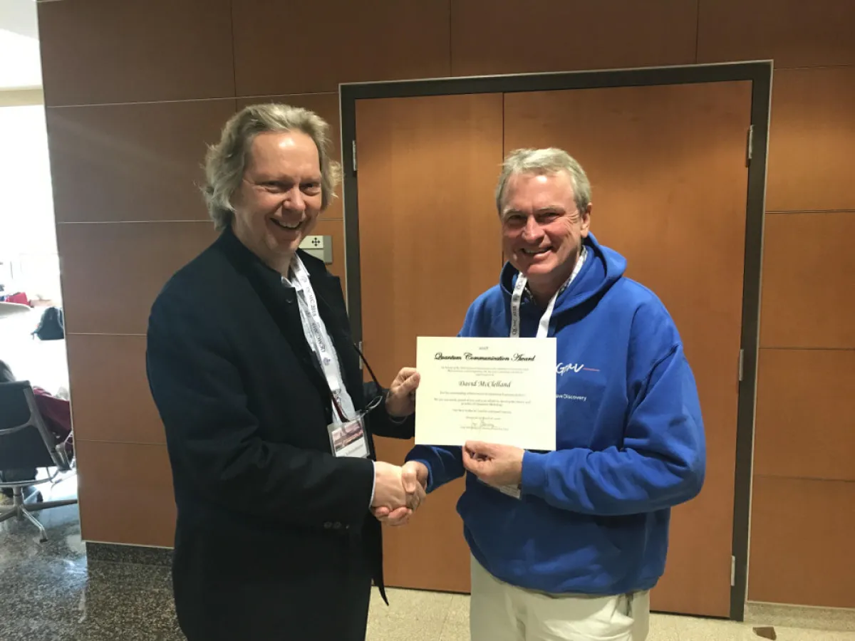 Prof McClelland receiving his award from Prof Joerg Schmiedmayer, Chair of the International Organisation for Quantum Communication, Measurement and Computation